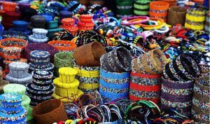 A vibrant display of handcrafted beaded baskets, bracelets, and accessories at a local market in Kenya.