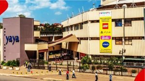 Yaya Centre shopping mall in Nairobi, Kenya, with a bustling entrance and Toyworld advertisement on the building.