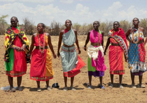 a group of people wearing colorful dresses