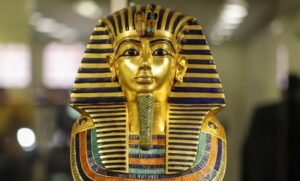 Golden funerary mask of King Tutankhamun, a masterpiece of ancient Egyptian art and craftsmanship.